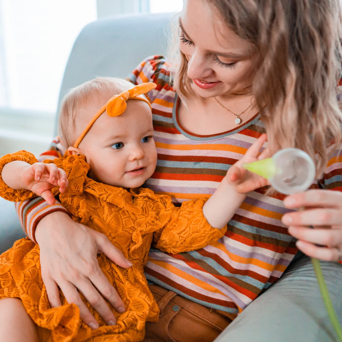 Cute little girl is trying to grab the colibri head right before the nasal aspiration