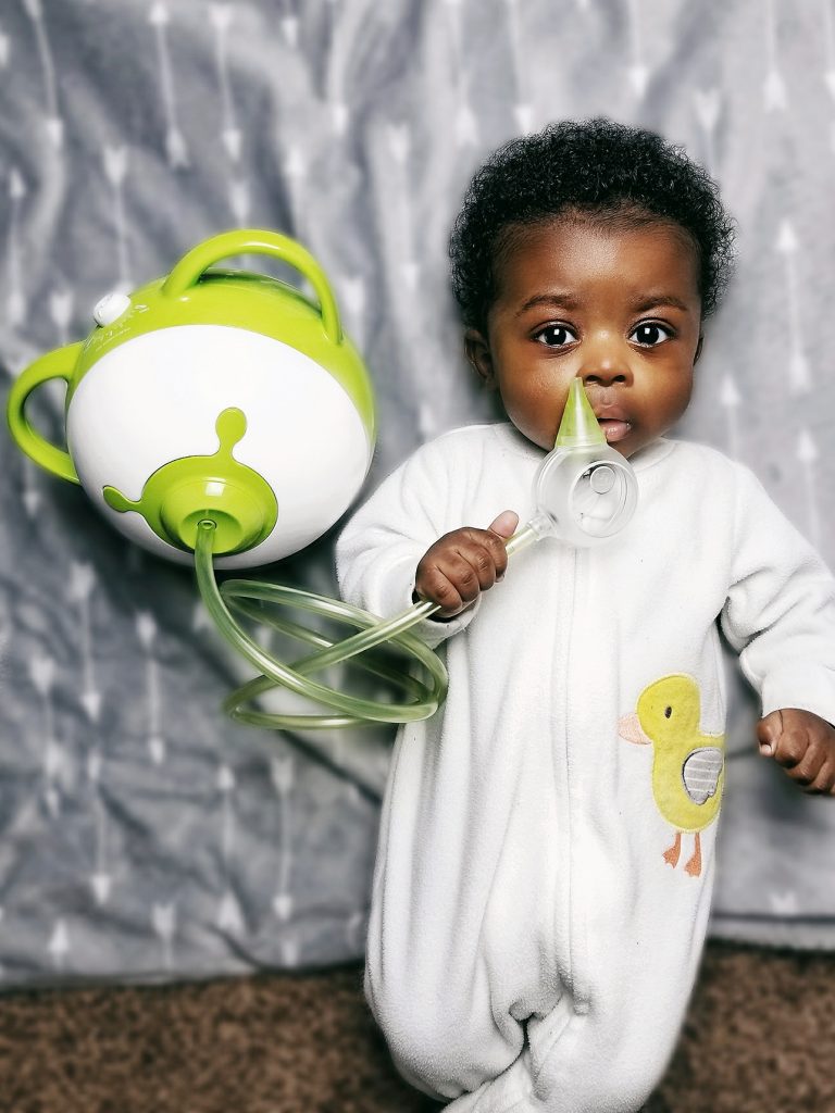 A little boy with the Nosiboo Pro Electric Nasal Aspirator