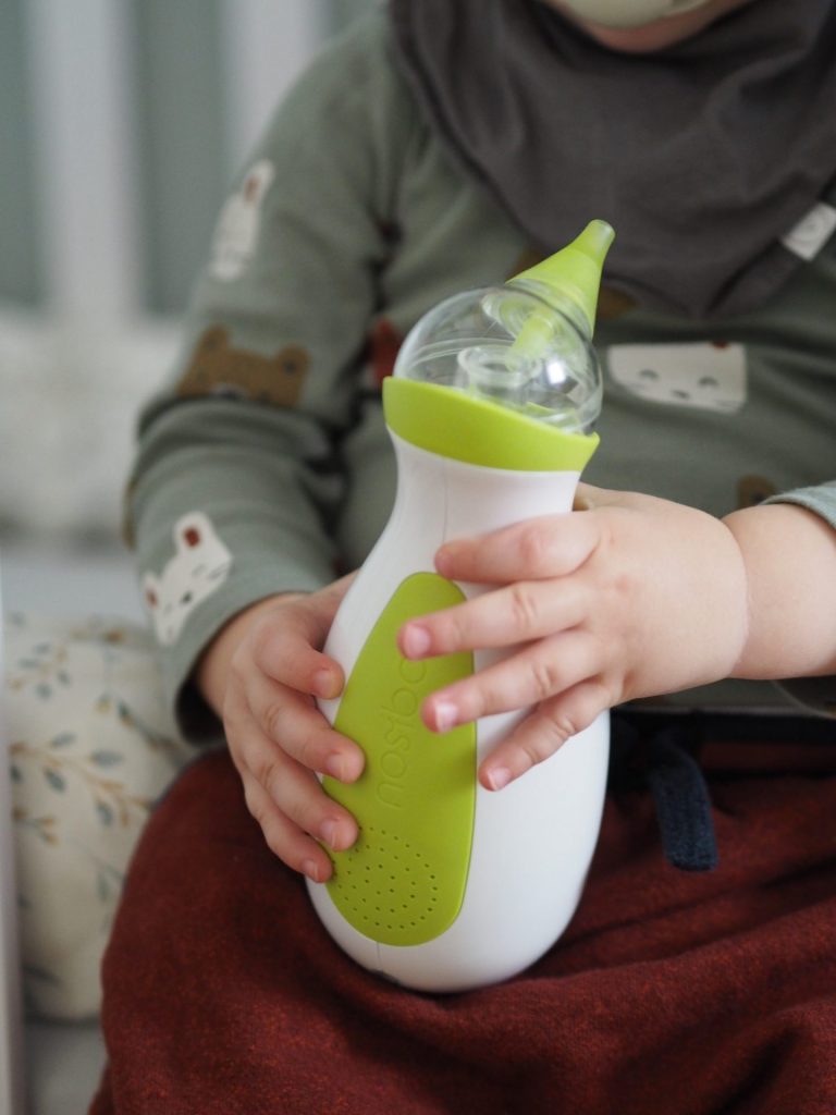 A little boy with the Nosiboo Go Portable Nasal Aspirator