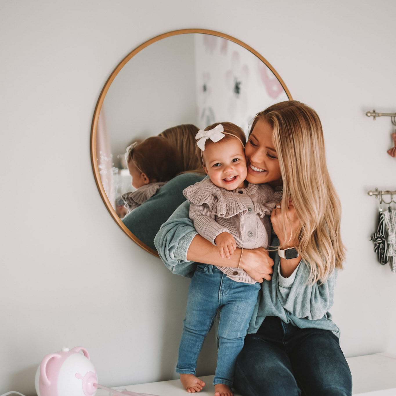 A pretty mother sitting with her cute daughter in the anteroom, next to the Nosiboo Pro Electric Nasal Aspirator